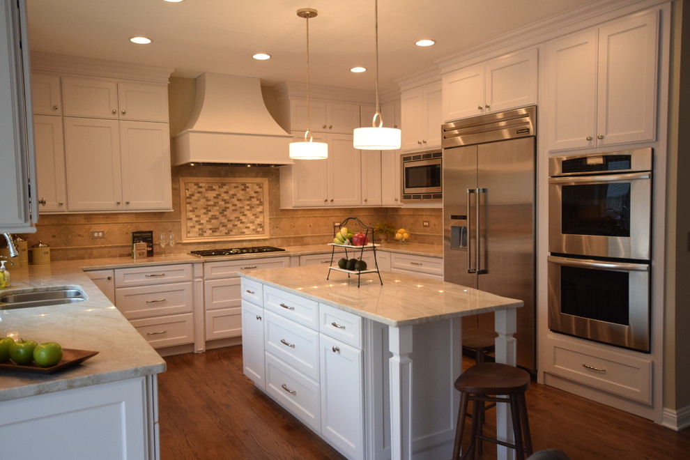Design ideas for a large transitional u-shaped open plan kitchen in Chicago with an undermount sink, recessed-panel cabinets, white cabinets, quartzite benchtops, green splashback, stone tile splashback, stainless steel appliances, dark hardwood floors and with island.