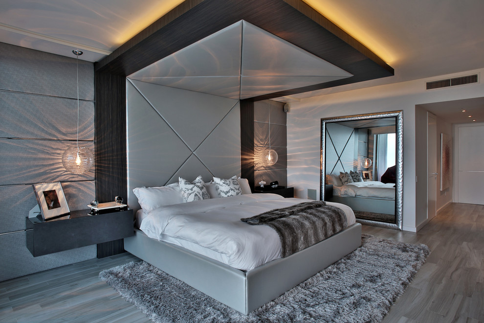 Large contemporary master bedroom in Miami with grey walls and porcelain floors.