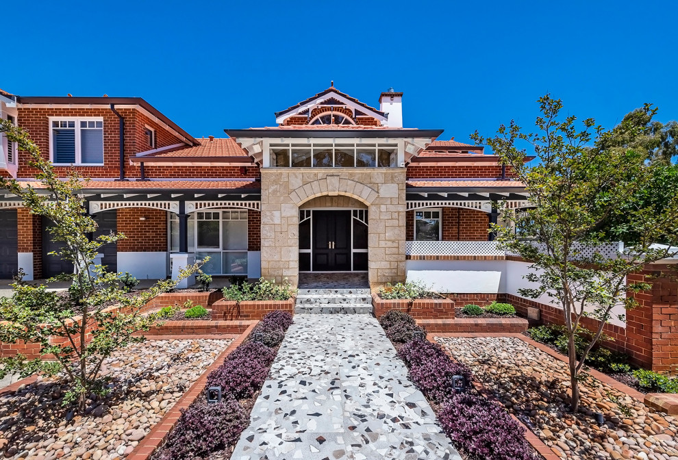 Large transitional two-storey brick multi-coloured house exterior in Perth with a gable roof and a tile roof.