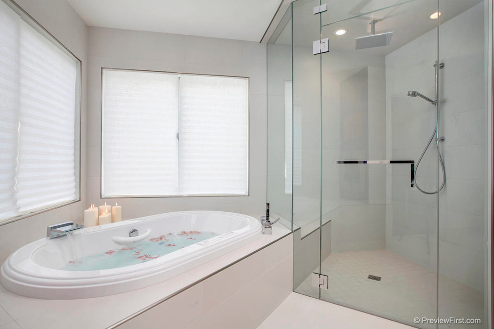 This is an example of a large contemporary master bathroom in San Diego with a corner tub, a corner shower, white tile and white walls.