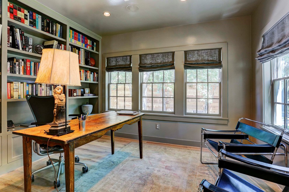 Country home office in Houston with light hardwood floors and a freestanding desk.