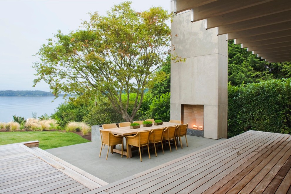 Contemporary backyard patio in Seattle with decking and an awning.