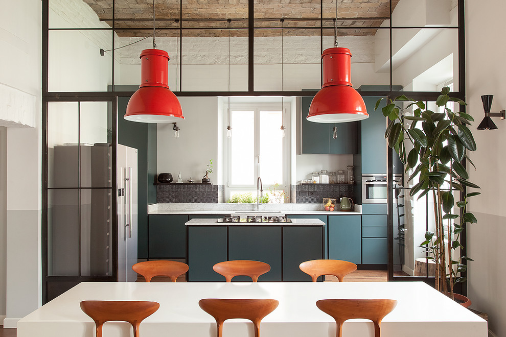 Inspiration for an industrial galley kitchen in Rome with flat-panel cabinets, blue cabinets, medium hardwood floors, with island, brown floor and white benchtop.