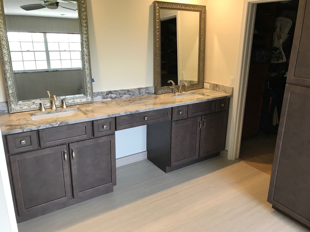 Mid-sized transitional porcelain tile and beige floor corner shower photo in Miami with recessed-panel cabinets, blue cabinets, beige walls, an undermount sink, quartzite countertops and a hinged shower door