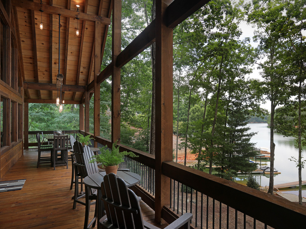 Inspiration for a country backyard deck in Atlanta with with dock and a roof extension.