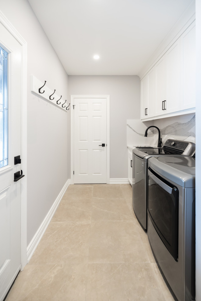 Example of a transitional light wood floor kitchen design in Toronto with an undermount sink, shaker cabinets, white cabinets, quartz countertops, white backsplash, quartz backsplash, stainless steel appliances and white countertops
