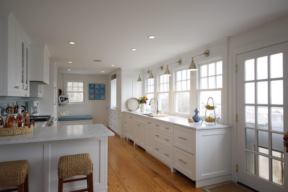 Inspiration for a transitional galley light wood floor eat-in kitchen remodel in Boston with shaker cabinets, granite countertops and white appliances