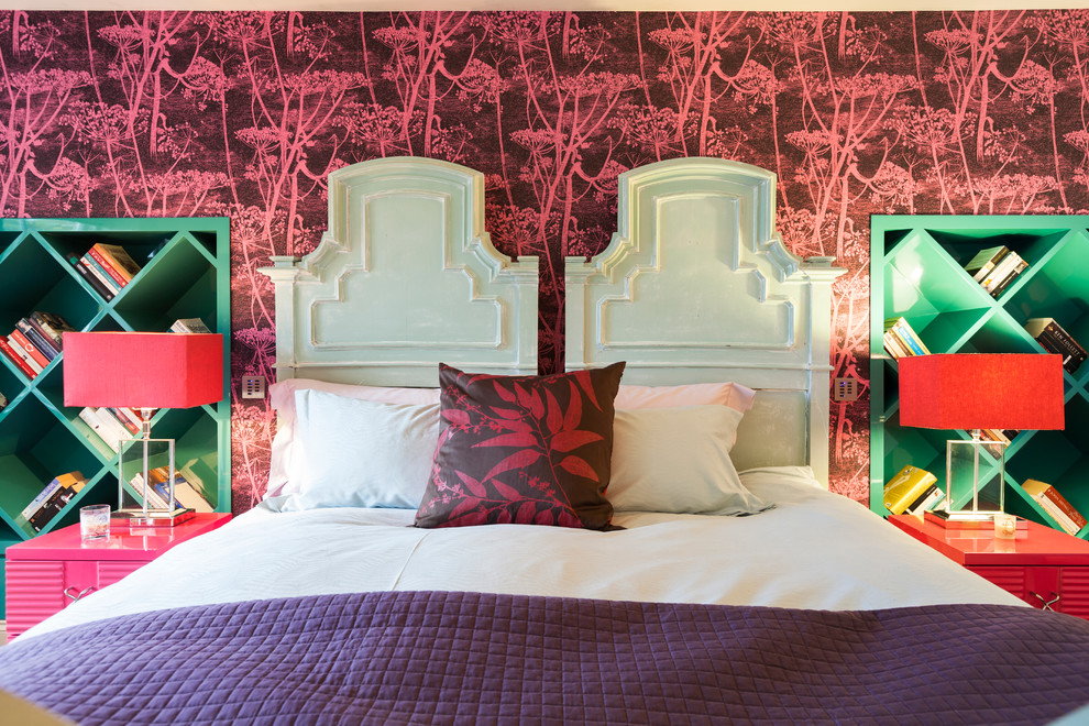 This is an example of a mid-sized transitional guest bedroom in London with multi-coloured walls.