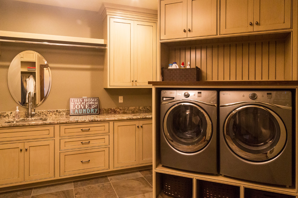Design ideas for a mid-sized traditional utility room in Other with an undermount sink, recessed-panel cabinets, beige cabinets, granite benchtops, beige walls, porcelain floors and a side-by-side washer and dryer.