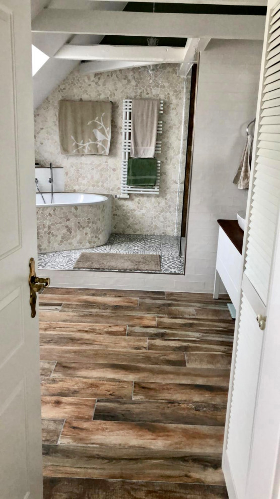 Photo of a medium sized farmhouse bathroom in Other with an alcove bath, a built-in shower, a wall mounted toilet, white tiles, metro tiles, green walls, wood-effect flooring, a vessel sink, an open shower and double sinks.