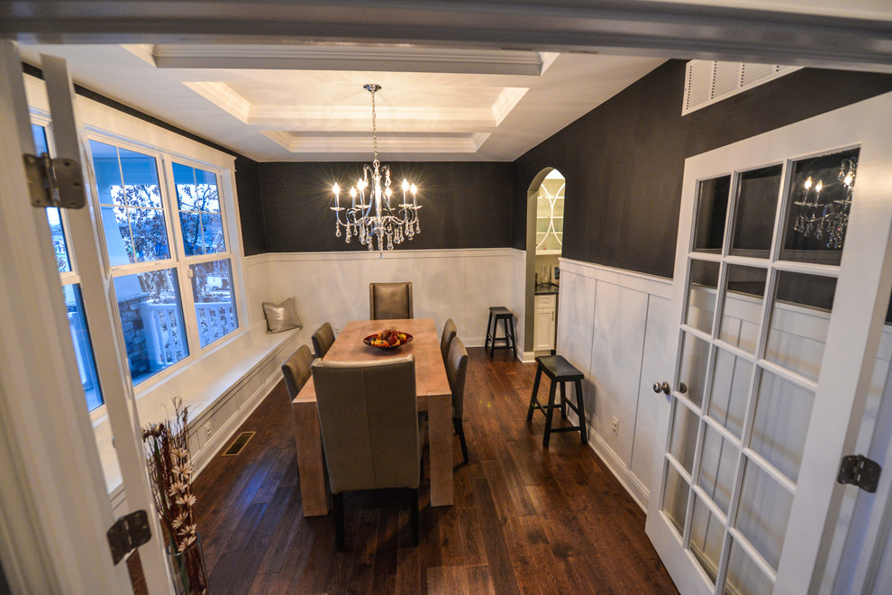 Arts and crafts separate dining room in Chicago with black walls and dark hardwood floors.