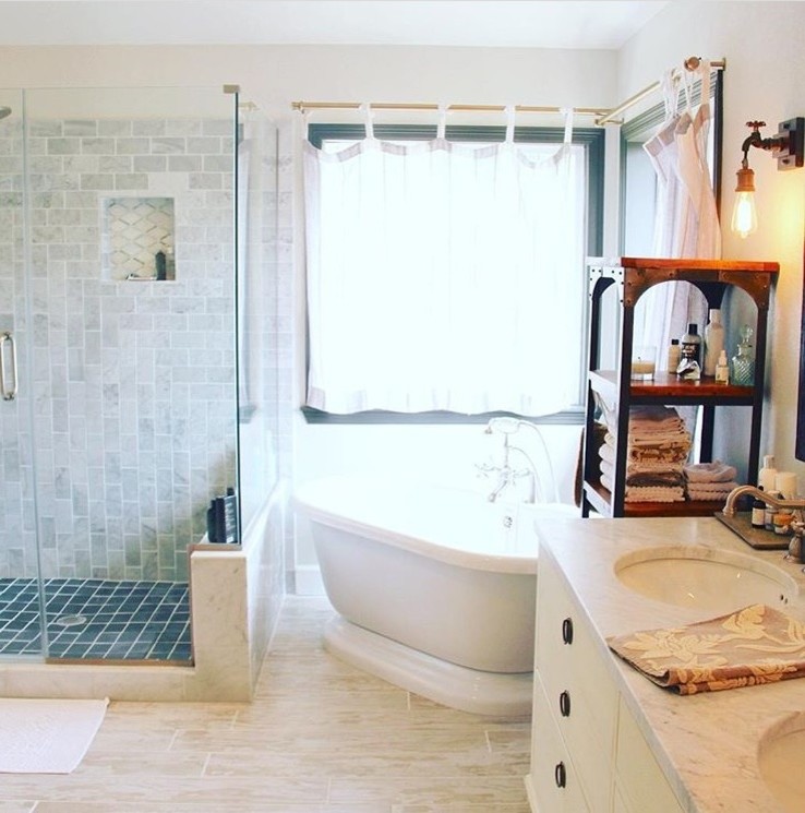 Inspiration for a mid-sized traditional master bathroom in Denver with white cabinets, a freestanding tub, white tile, marble, grey walls, ceramic floors, an undermount sink, marble benchtops, white floor and a hinged shower door.