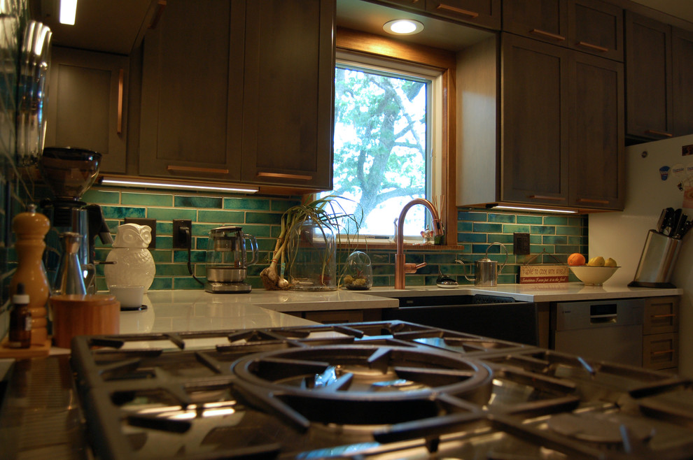 Example of a transitional l-shaped light wood floor and multicolored floor open concept kitchen design with a farmhouse sink, shaker cabinets, gray cabinets, quartzite countertops, blue backsplash, ceramic backsplash, stainless steel appliances and an island