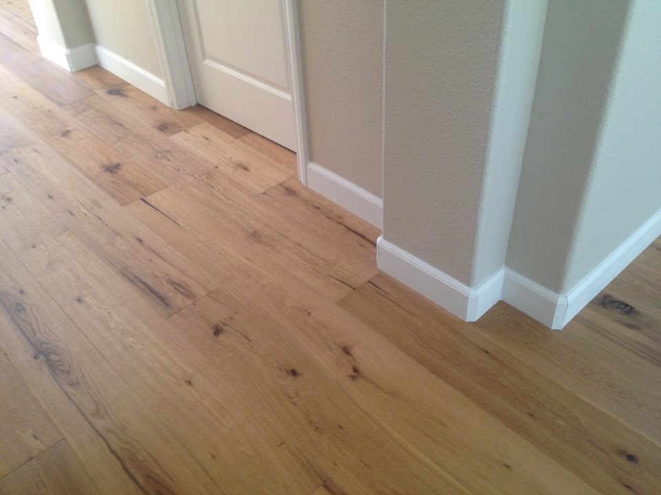 Design ideas for a traditional hallway in Sacramento with beige walls, light hardwood floors and brown floor.