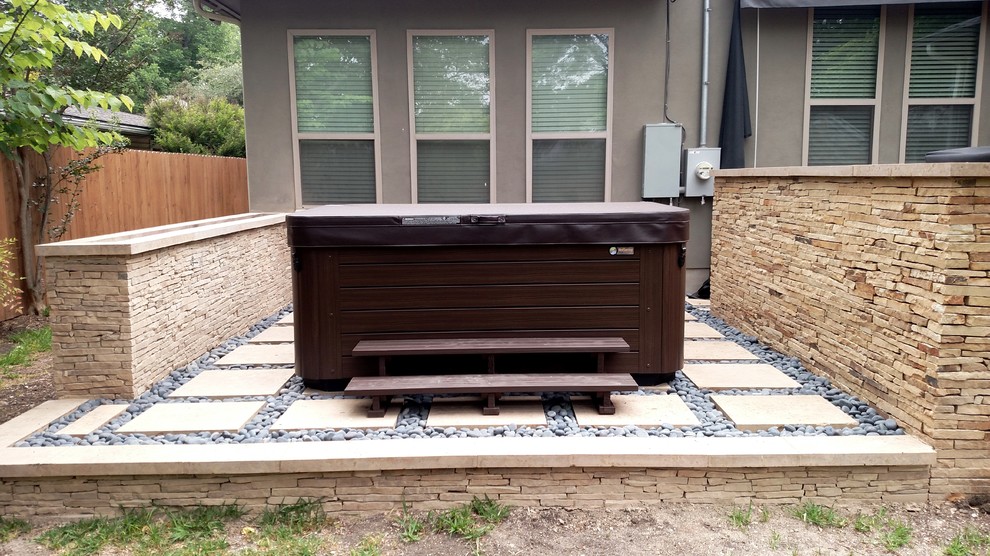 This is an example of a large country patio in Austin with a fire feature and natural stone pavers.