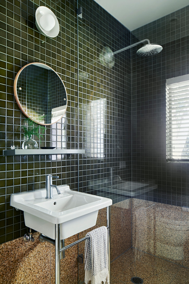 Photo of a contemporary bathroom in Melbourne with green tile, a console sink and brown floor.