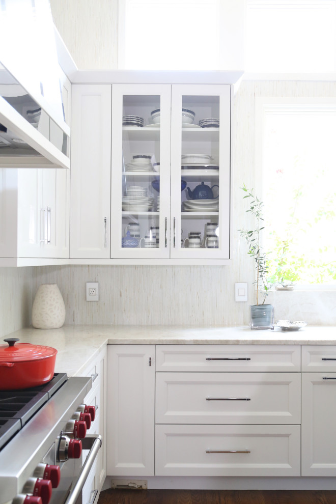 Eat-in kitchen - huge transitional medium tone wood floor and brown floor eat-in kitchen idea with an undermount sink, recessed-panel cabinets, white cabinets, quartzite countertops, white backsplash, ceramic backsplash, stainless steel appliances, an island and white countertops