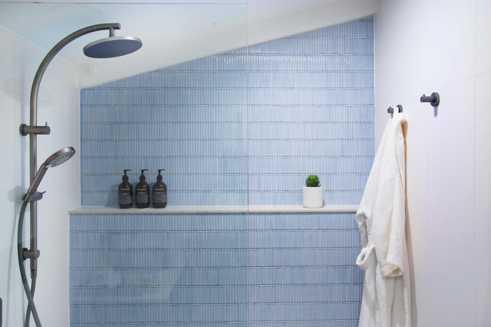 Small urban master blue tile and ceramic tile ceramic tile and brown floor bathroom photo in Brisbane with flat-panel cabinets, gray cabinets, a one-piece toilet, white walls, a vessel sink, solid surface countertops, white countertops and a floating vanity