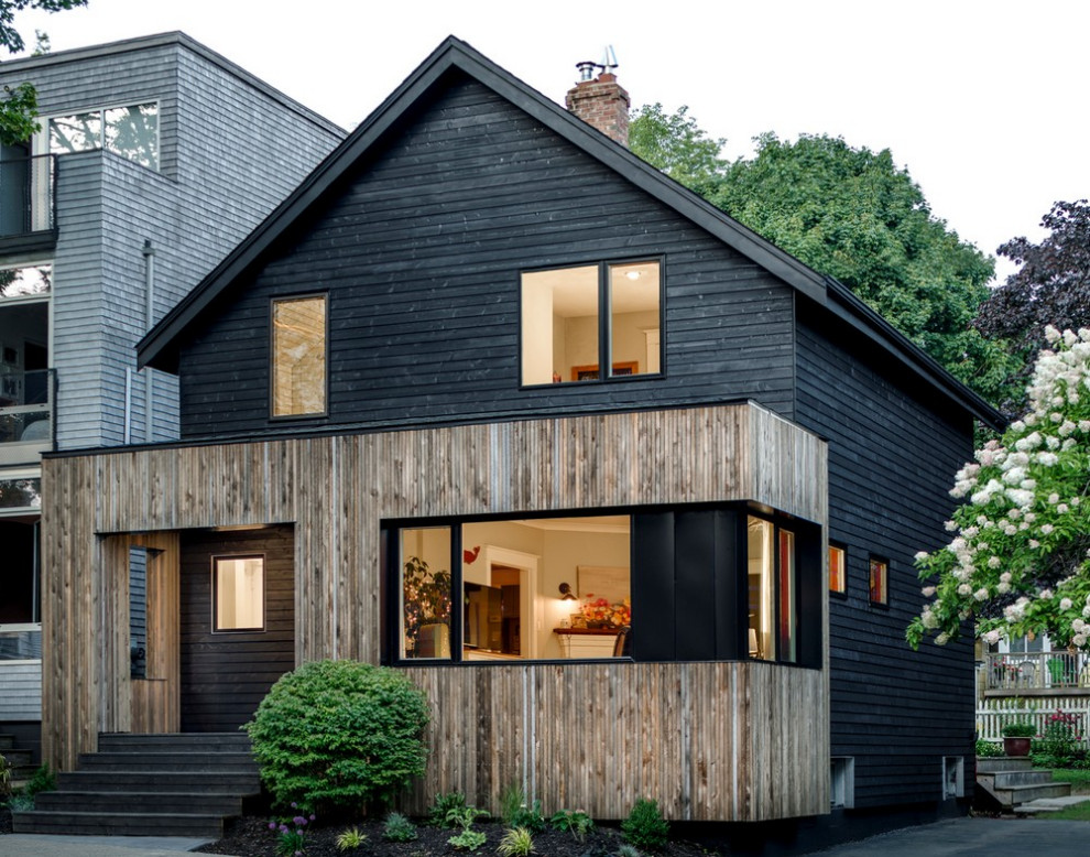 This is an example of a modern black exterior in Other with wood siding.