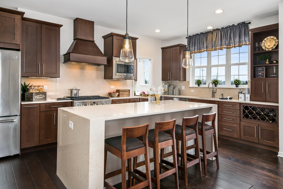 Eat-in kitchen - large transitional l-shaped dark wood floor eat-in kitchen idea in Chicago with an undermount sink, shaker cabinets, dark wood cabinets, quartz countertops, beige backsplash, stone slab backsplash, stainless steel appliances and an island