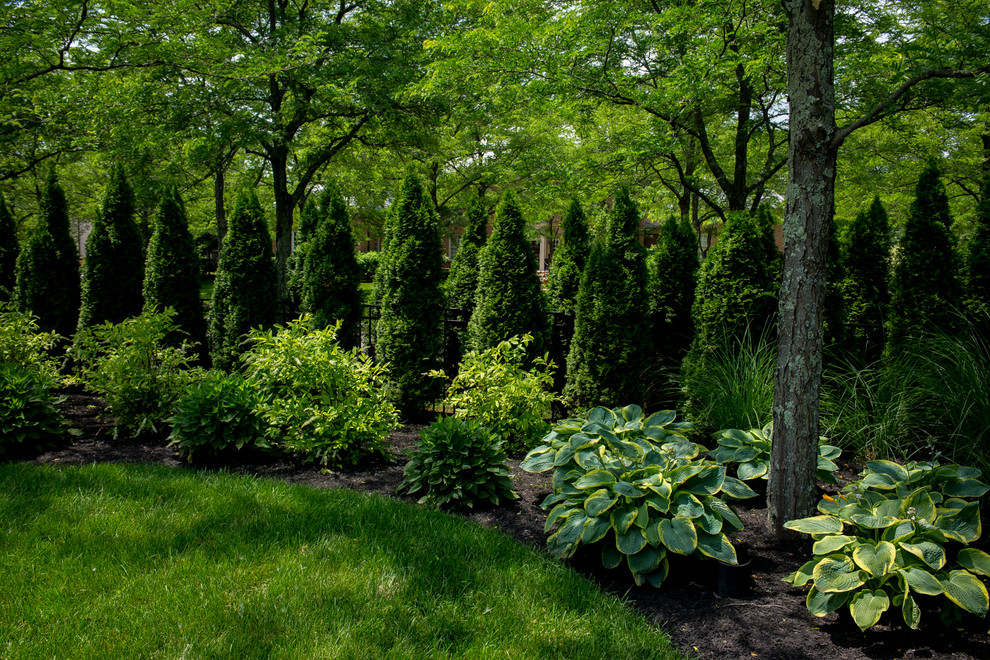 Design ideas for a large traditional backyard partial sun garden in Columbus with mulch.