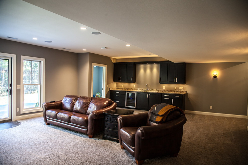 Example of a large transitional carpeted and beige floor basement design with beige walls and a standard fireplace