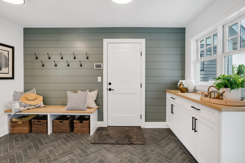 Mid-sized transitional mudroom in Minneapolis with white walls, porcelain floors, a single front door, a white front door, grey floor and planked wall panelling.