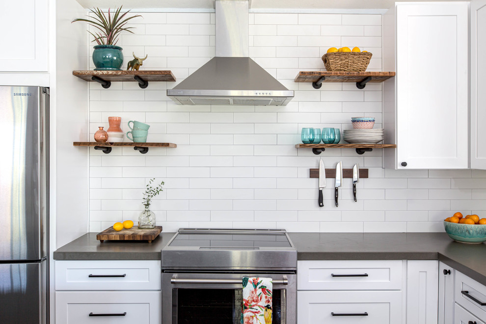 Inspiration for an eat-in kitchen in San Diego with an undermount sink, shaker cabinets, white cabinets, quartzite benchtops, white splashback, subway tile splashback, stainless steel appliances, vinyl floors, with island, brown floor and white benchtop.