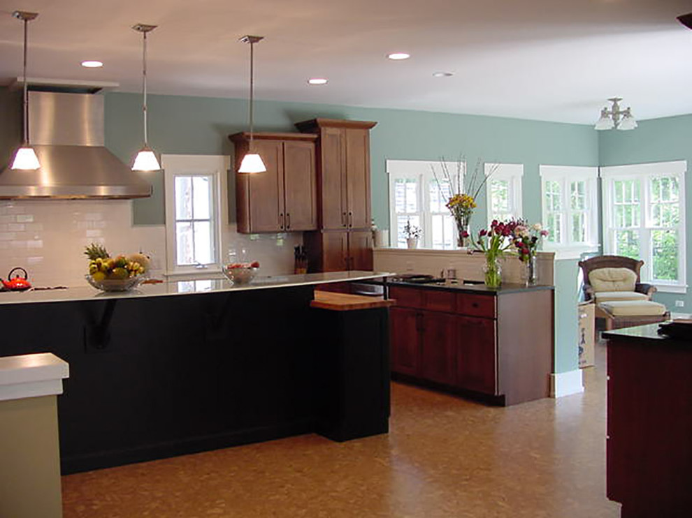 Design ideas for a large arts and crafts u-shaped eat-in kitchen in Chicago with white splashback, subway tile splashback, glass benchtops, cork floors, stainless steel appliances, an undermount sink, shaker cabinets, medium wood cabinets and with island.