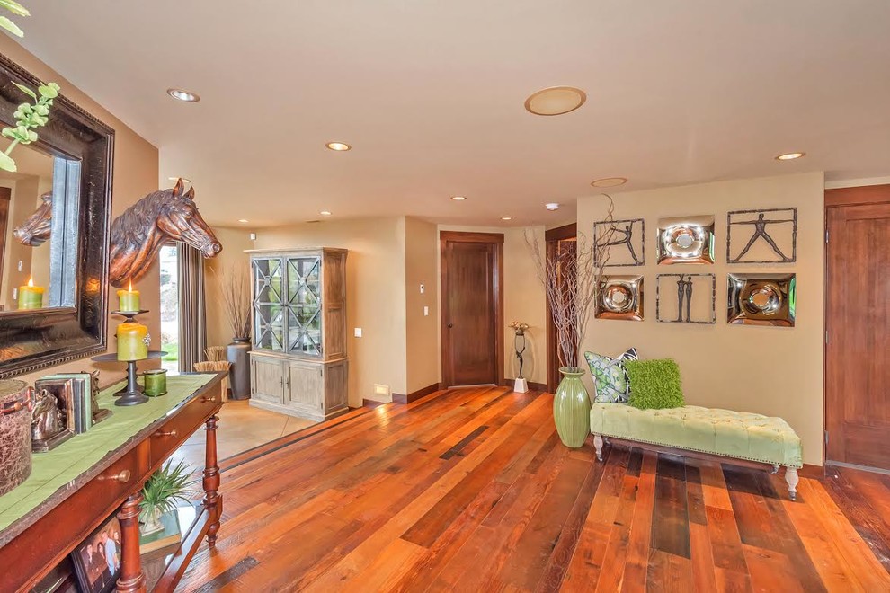 Large contemporary foyer in Seattle with beige walls, dark hardwood floors, a double front door and a glass front door.