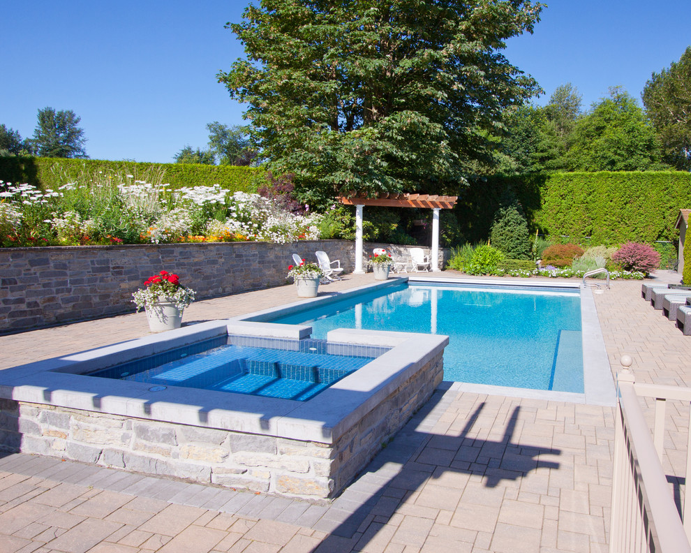 Inspiration for a traditional backyard rectangular pool in Vancouver with a hot tub.