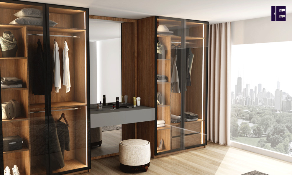 Inspiration for a large contemporary standard wardrobe in London with glass-front cabinets and feature lighting.