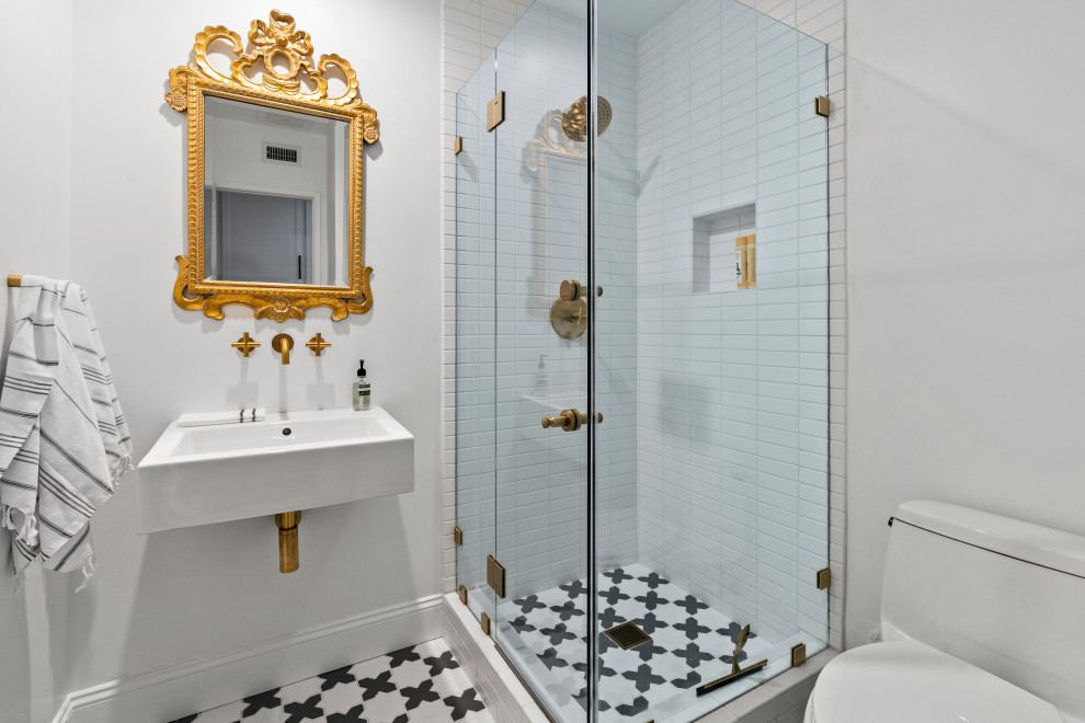 Small country 3/4 bathroom in Los Angeles with a corner shower, a two-piece toilet, white tile, cement tile, white walls, cement tiles, a pedestal sink, grey floor, a hinged shower door, a single vanity and a freestanding vanity.