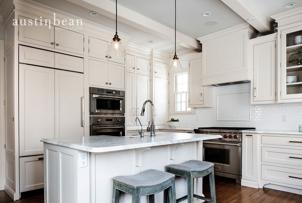 Eat-in kitchen - transitional l-shaped medium tone wood floor eat-in kitchen idea with a farmhouse sink, glass-front cabinets, white cabinets, marble countertops, white backsplash, subway tile backsplash, stainless steel appliances, gray walls and an island