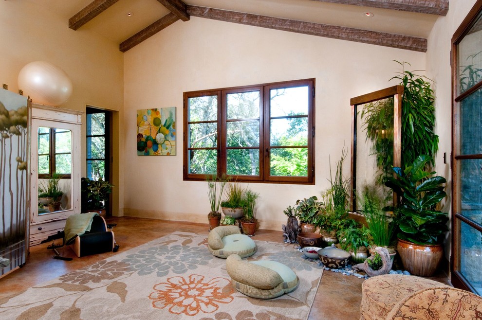 Large mediterranean home yoga studio in Boise with beige walls, travertine floors and brown floor.