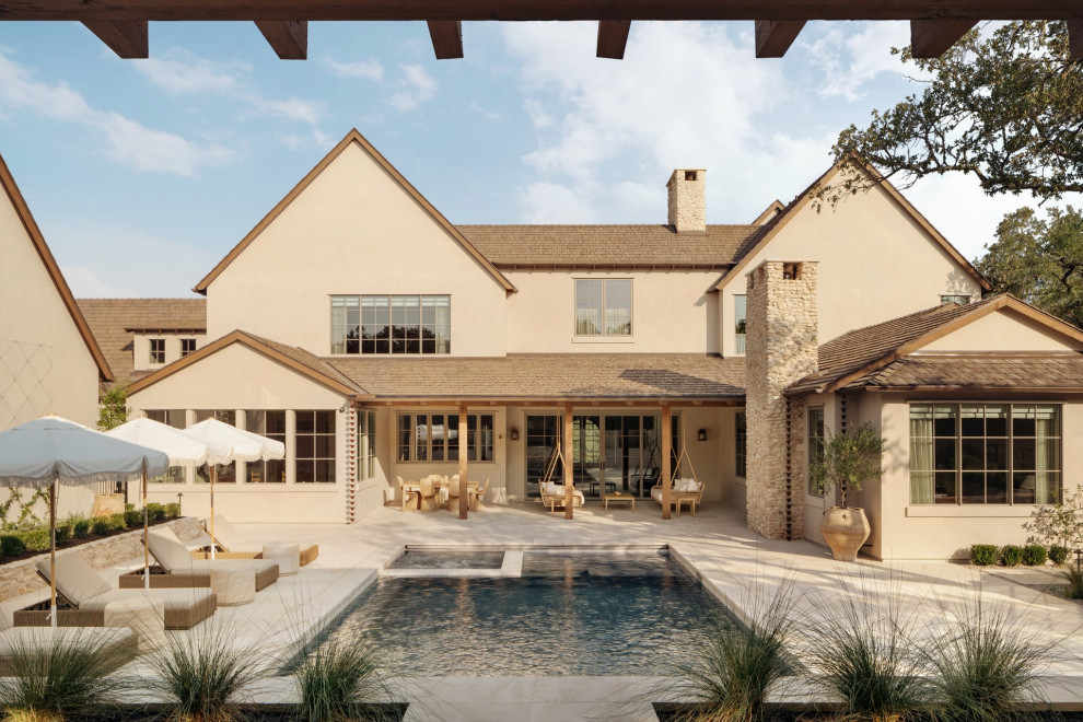 Example of a transitional backyard rectangular pool design in Austin
