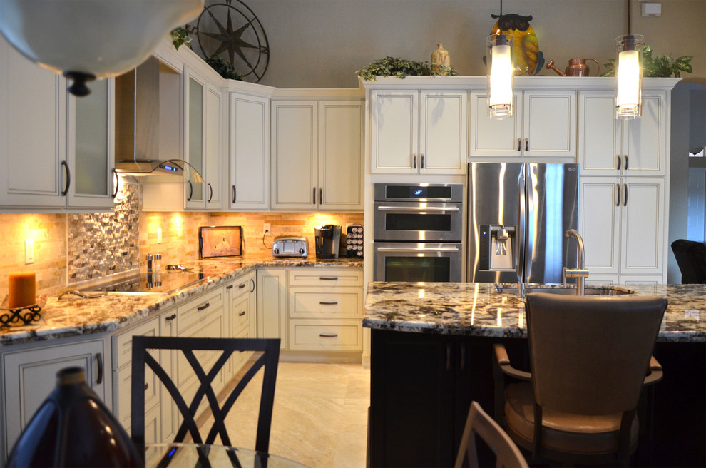 Example of a mid-sized transitional l-shaped open concept kitchen design in Miami with an undermount sink, flat-panel cabinets, white cabinets, granite countertops, beige backsplash, stone tile backsplash, stainless steel appliances and an island