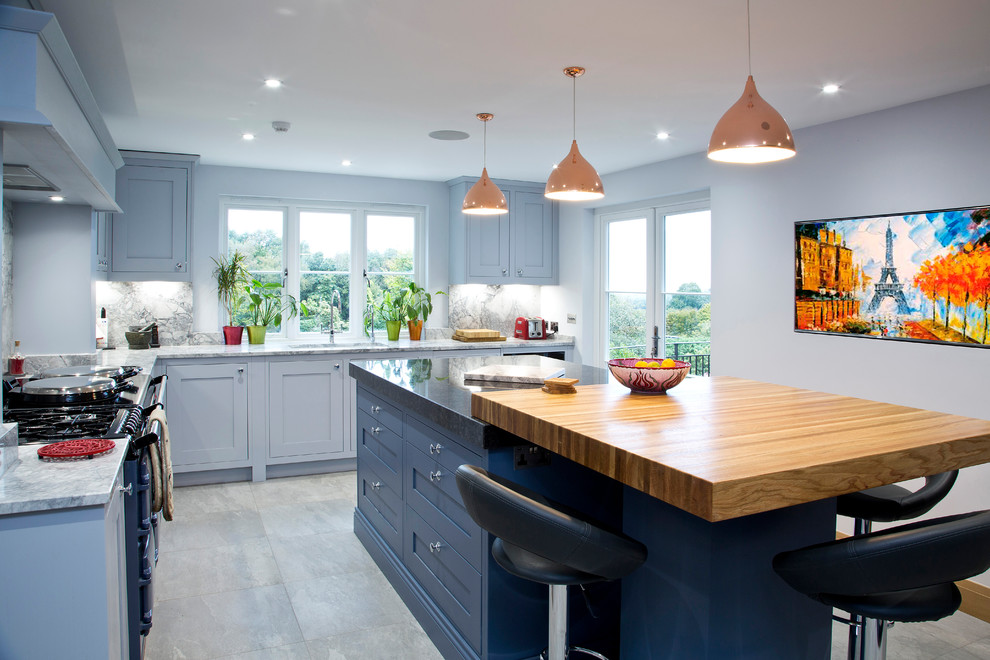 Photo of a mid-sized transitional u-shaped separate kitchen in Kent with shaker cabinets, granite benchtops, grey splashback, stone slab splashback, with island, an undermount sink and blue cabinets.