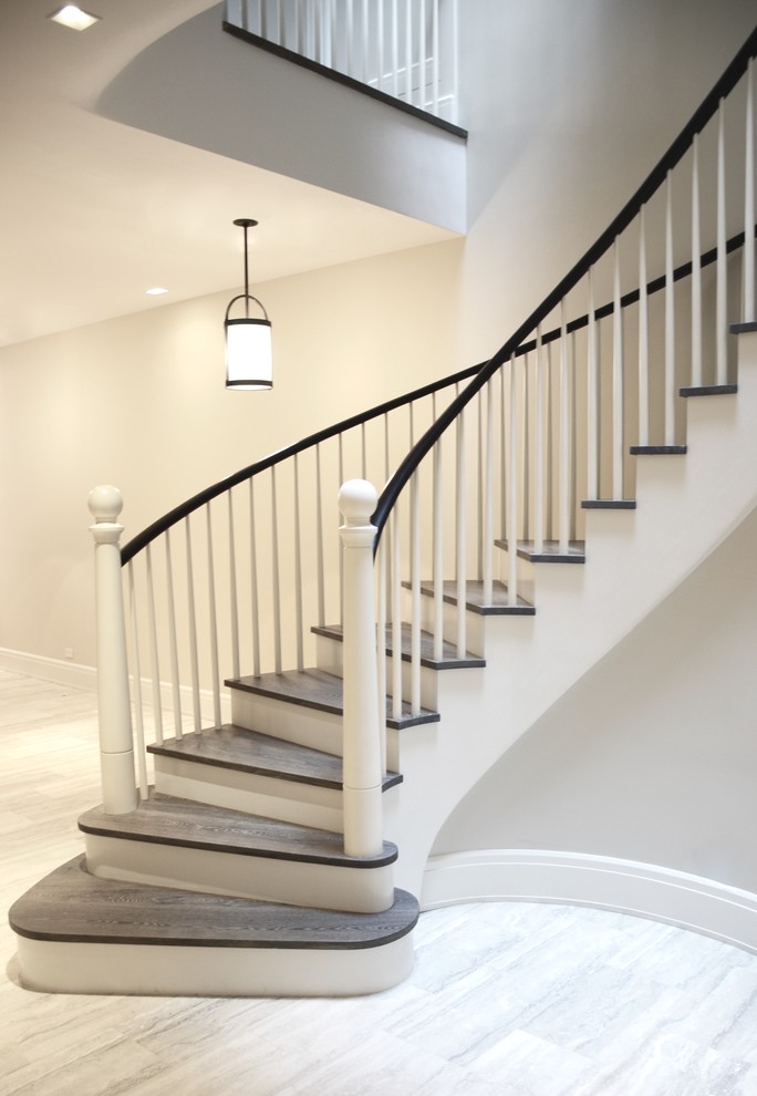 Staircase - large transitional wooden curved wood railing staircase idea with painted risers