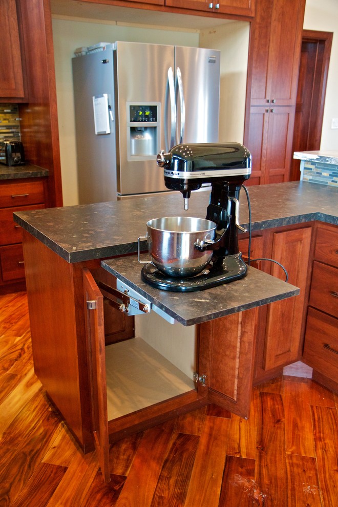 Example of a large l-shaped light wood floor open concept kitchen design with a drop-in sink, shaker cabinets, dark wood cabinets, laminate countertops, multicolored backsplash, stone tile backsplash, stainless steel appliances and an island
