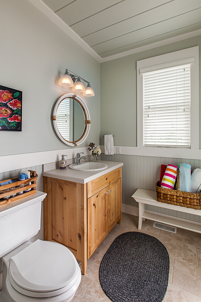 Design ideas for a beach style powder room in Grand Rapids with light wood cabinets, grey walls, a drop-in sink, engineered quartz benchtops, beige floor, shaker cabinets, a two-piece toilet, grey benchtops, a freestanding vanity, timber and decorative wall panelling.