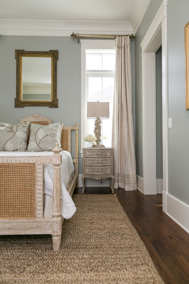 Country bedroom in Charleston with grey walls, dark hardwood floors and brown floor.