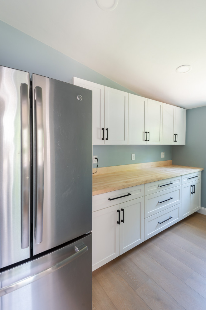 Small transitional galley medium tone wood floor and brown floor kitchen pantry photo in Boston with shaker cabinets, white cabinets, wood countertops, stainless steel appliances, no island and brown countertops