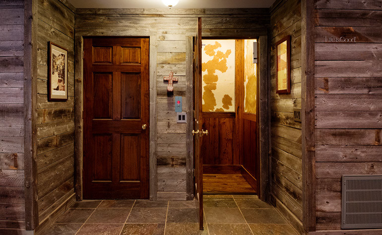Hallway - mid-sized rustic medium tone wood floor hallway idea in Nashville with brown walls