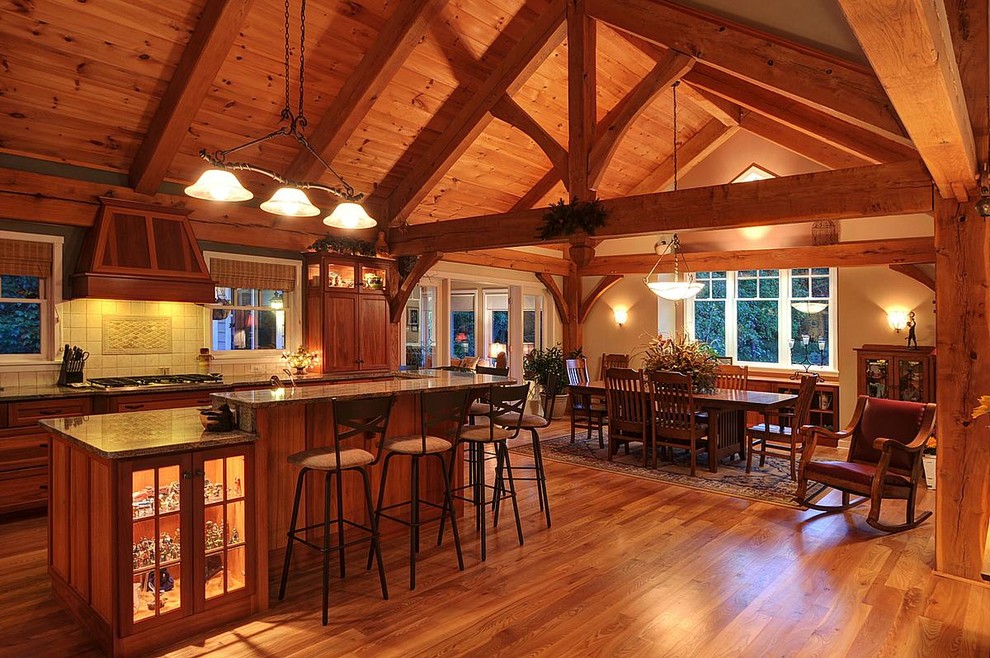 Example of a mid-sized mountain style galley medium tone wood floor eat-in kitchen design in Milwaukee with an undermount sink, recessed-panel cabinets, medium tone wood cabinets, white backsplash, ceramic backsplash and an island