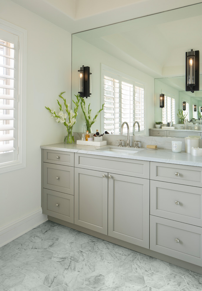 Inspiration for a transitional bathroom in Denver with shaker cabinets, grey cabinets, white walls, an undermount sink, grey floor and white benchtops.