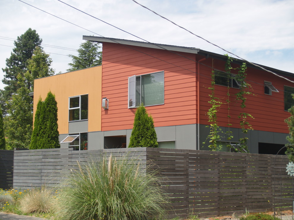 Contemporary two-storey exterior in Seattle with mixed siding.