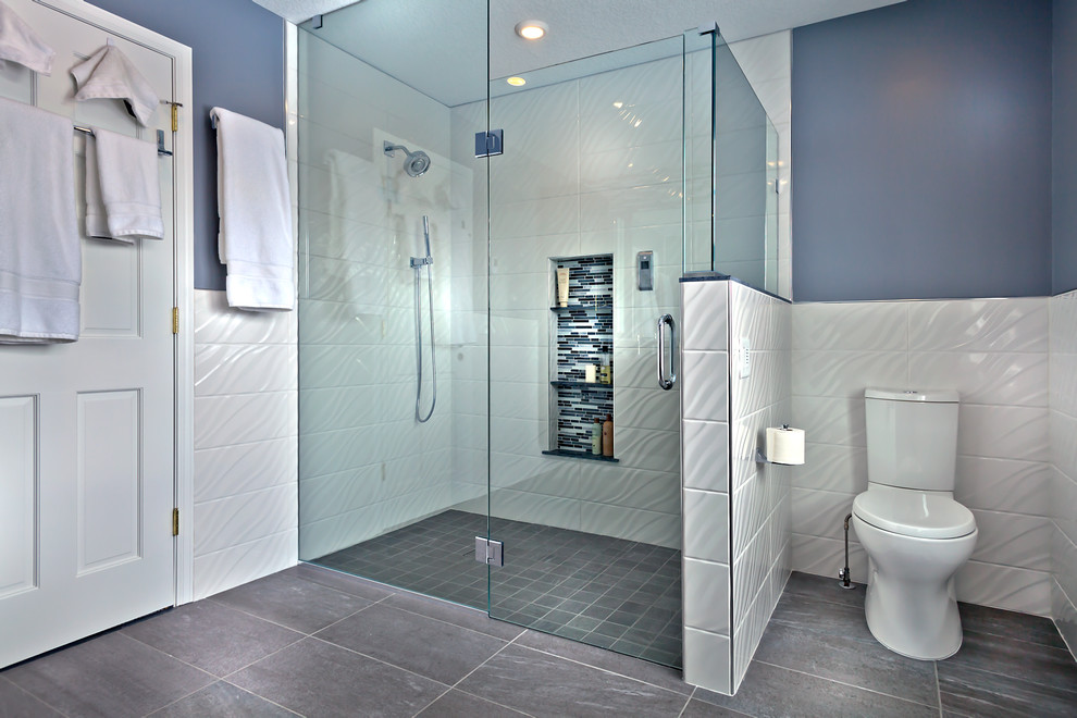 Design ideas for a mid-sized contemporary master bathroom in Minneapolis with an undermount sink, flat-panel cabinets, black cabinets, granite benchtops, a curbless shower, a two-piece toilet, multi-coloured tile, glass tile, grey walls and porcelain floors.