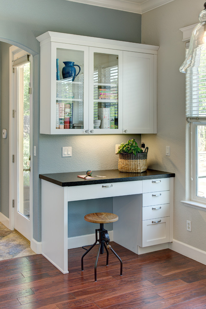 Inspiration for a traditional home studio in Sacramento with blue walls, dark hardwood floors and a freestanding desk.