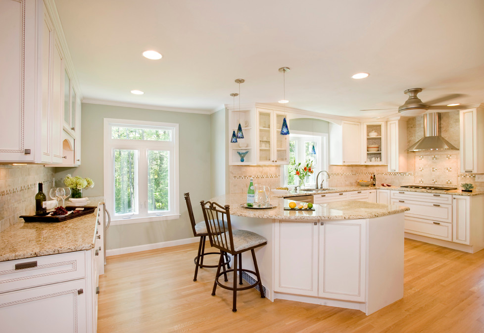 Mid-sized transitional u-shaped light wood floor eat-in kitchen photo in Boston with a double-bowl sink, recessed-panel cabinets, white cabinets, granite countertops, multicolored backsplash, ceramic backsplash, stainless steel appliances and a peninsula